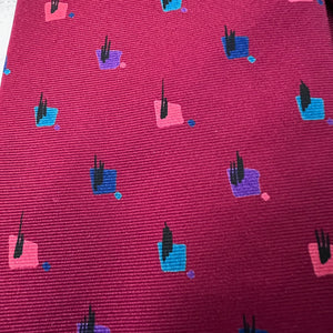 Patterned fabric with small colorful shapes on a red background