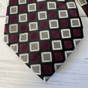 Patterned tie with geometric design on a white background