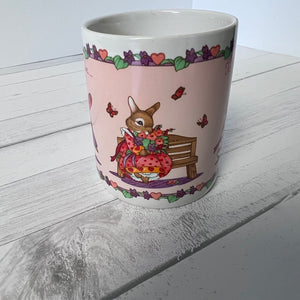 Ceramic mug with a rabbit design on a wooden surface