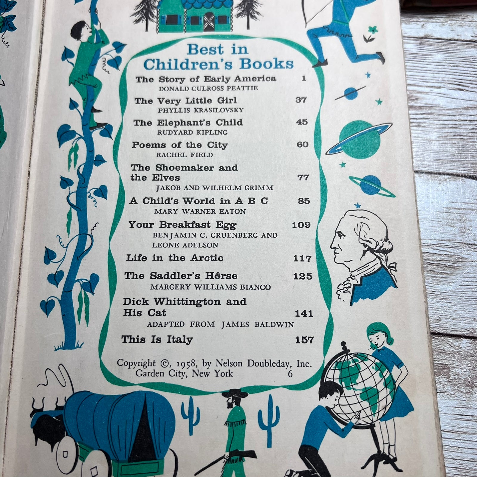 A vintage children's book cover or booklet page with illustrated cover art and a printed table of contents titled 'Best in Children's Books.' The page is photographed on a light wood surface.