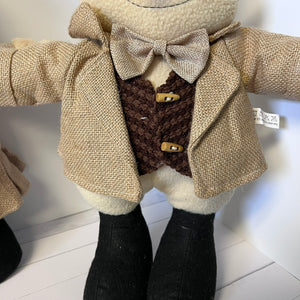 snowman wearing a textured beige coat with a bow tie on a white background