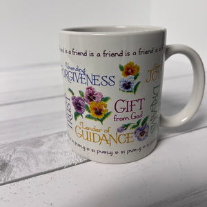 White mug with floral designs and text on a white background