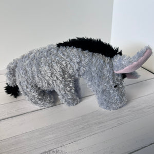 Plush donkey toy on a light wooden surface