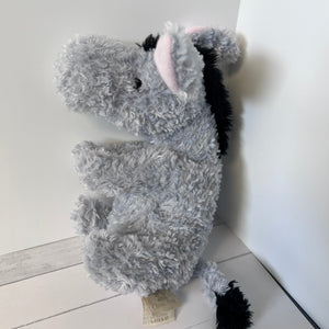 Plush donkey toy on a white floor