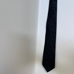 Black patterned tie on a white background