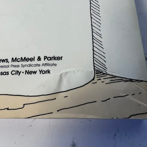 Close-up of a paper cutout with text and a geometric design on a white background.