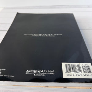 Back cover of a book with text and a barcode on a light wooden surface