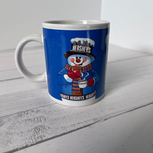 Hershey's snowman mug on a wooden surface