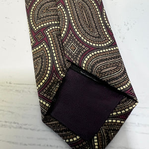 Patterned tie and pocket square on a textured surface