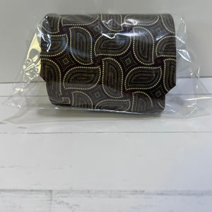 Patterned belt in packaging on a white surface