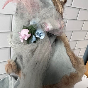 Robin Woods doll headpiece with flowers and tulle on a tiled wall background