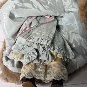 Light blue pet dress with lace details on a white surface