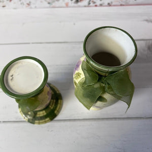 Two green ceramics with ribbons on a white wooden surface