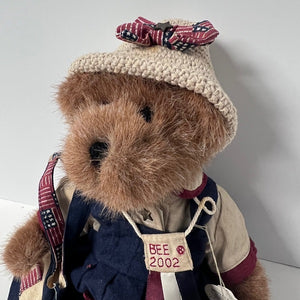 Teddy bear with a hat, scarf, and backpack on a plain background