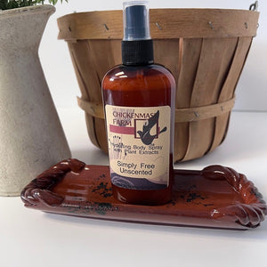Body spray bottle on a decorative tray with a wooden basket in the background