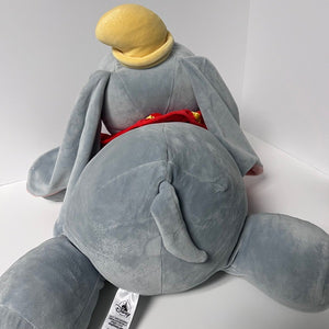 Plush toy elephant with a yellow hat on a white background