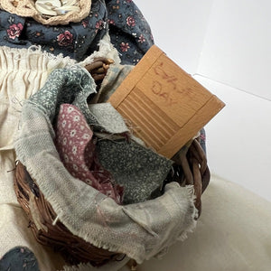 Basket with fabric pieces and a washboard on a white surface