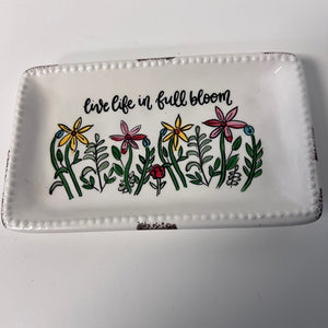 Decorative tray with floral design and 'live life in full bloom' text on a white background