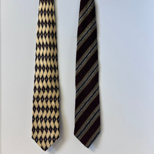 Two patterned ties on a light gray background