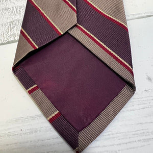 Striped tie with purple, beige, and red pattern on a white background