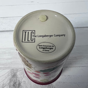 Bottom view of a Longaberger Company product with branding on a wooden surface