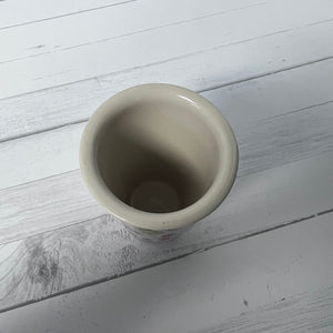 Ceramic cup on a light wooden surface