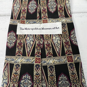 Decorative fabric with intricate patterns and a label from The Metropolitan Museum of Art.