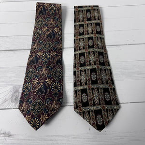 Two patterned ties on a light wooden surface
