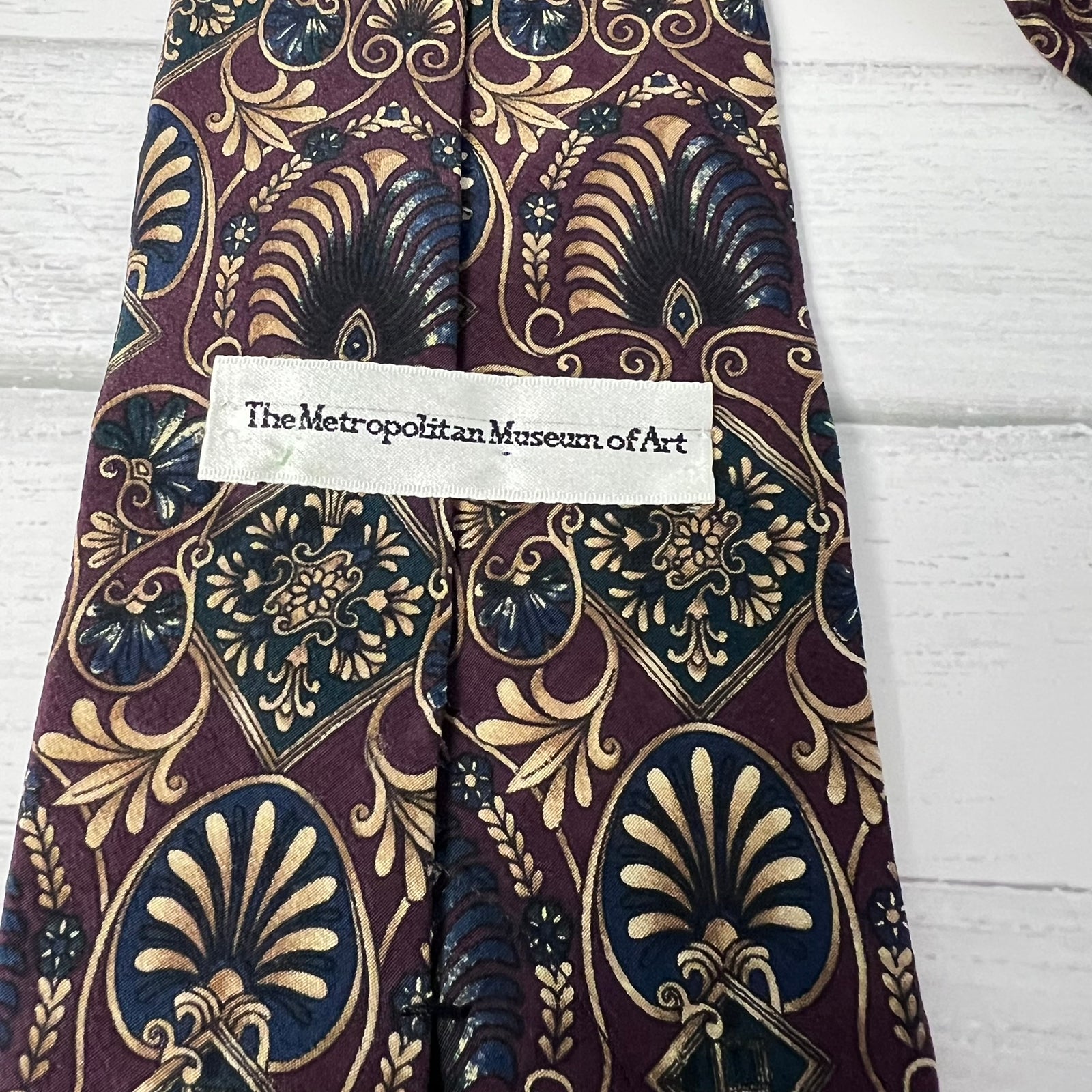 Patterned tie with a label on a wooden surface
