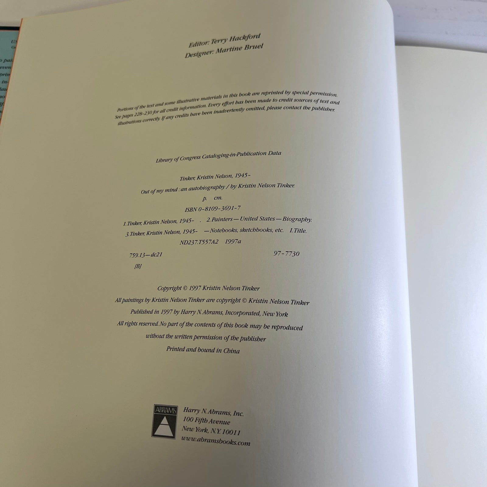 A photographed interior page from a printed book or publication, showing publication credits, copyright text, and publisher information on an off-white page.