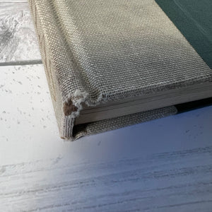 Book with textured cover on a white surface