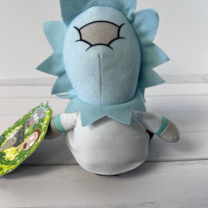 Plush toy resembling a character with light blue hair and white body on a wooden surface.
