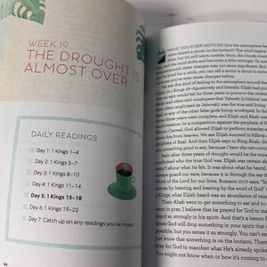 Open book with daily readings and a watercolor illustration of a green plant and red flower.