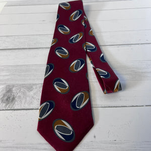 Maroon tie with pattern on a light wooden surface
