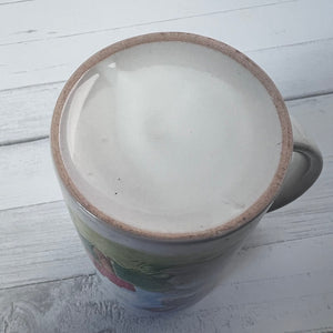 Ceramic mug with a brown rim on a light wooden surface