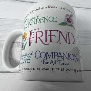 White mug with motivational text and floral designs on a light wooden background