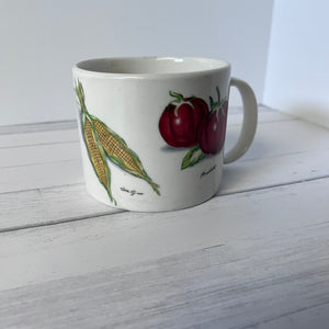 Mug with fruit design on a white wooden surface