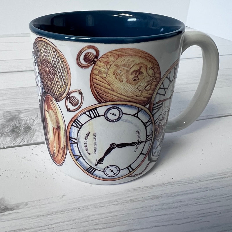 Mug with clock and pocket watch design on a white wooden surface