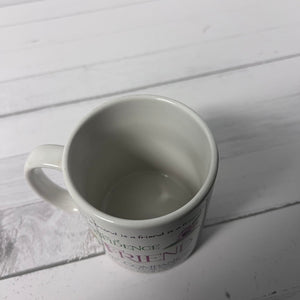 White mug with text on a light wooden surface
