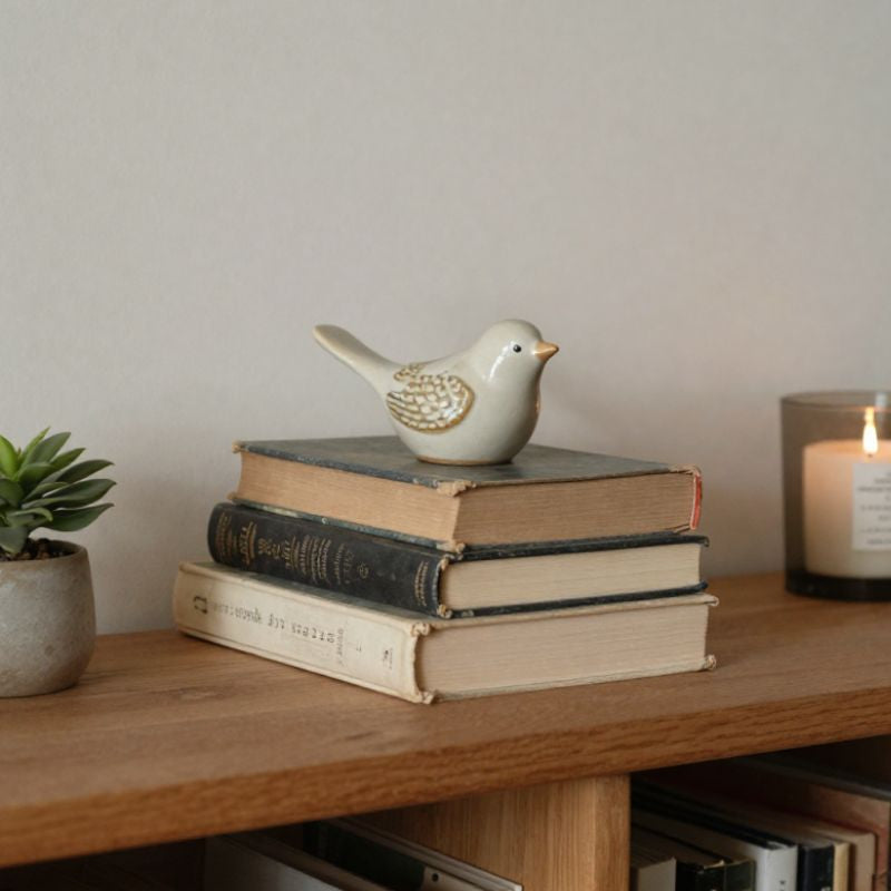 vintage book stack with bird figurine