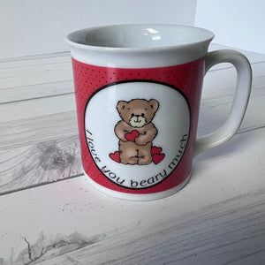 Mug with teddy bear design and text on a wooden surface