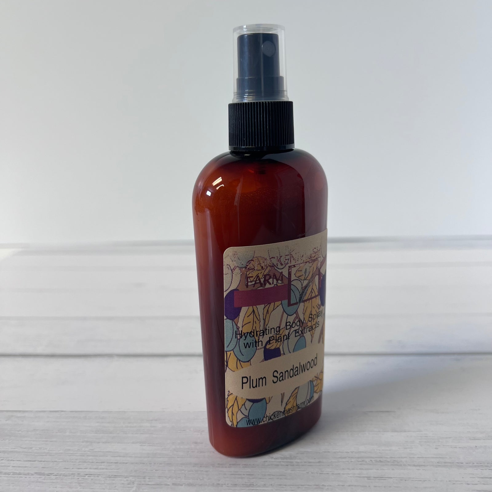 Brown spray bottle with a label on a light wooden surface