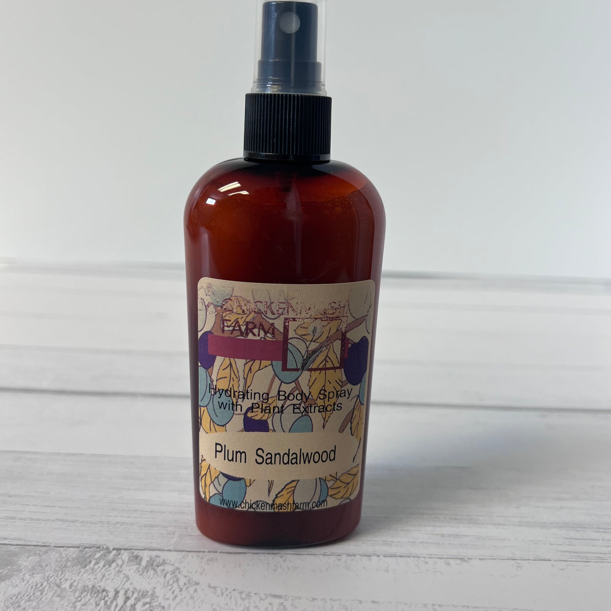Brown spray bottle with a label on a white wooden surface