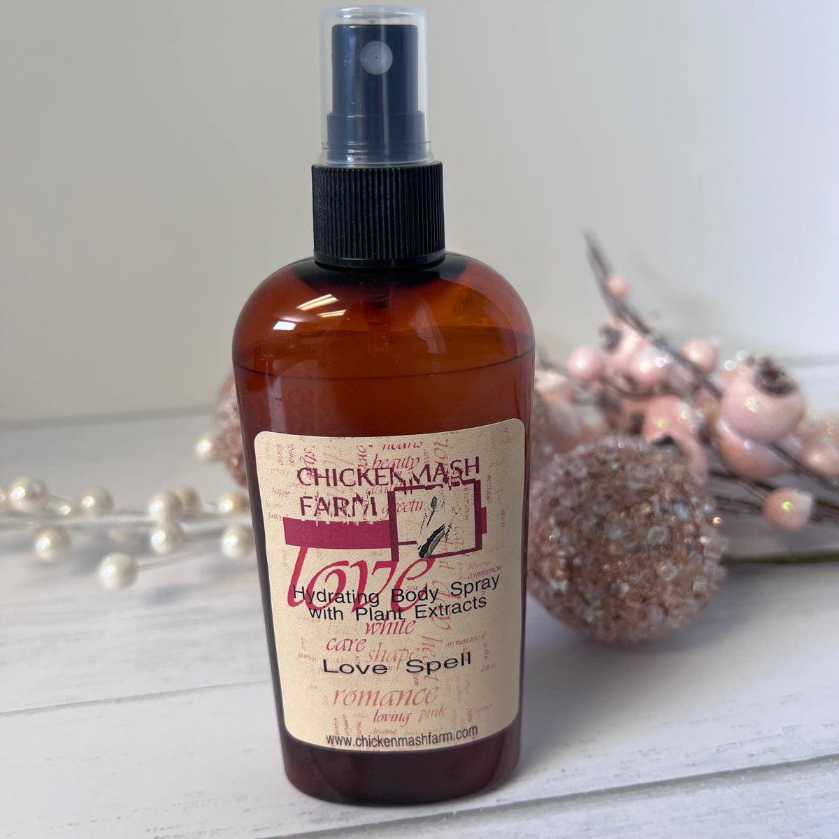 Love spell body spray with decorative background elements