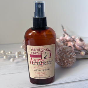 Love spell body spray with decorative background elements
