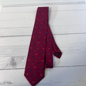 Maroon tie with small pattern on a light wooden surface