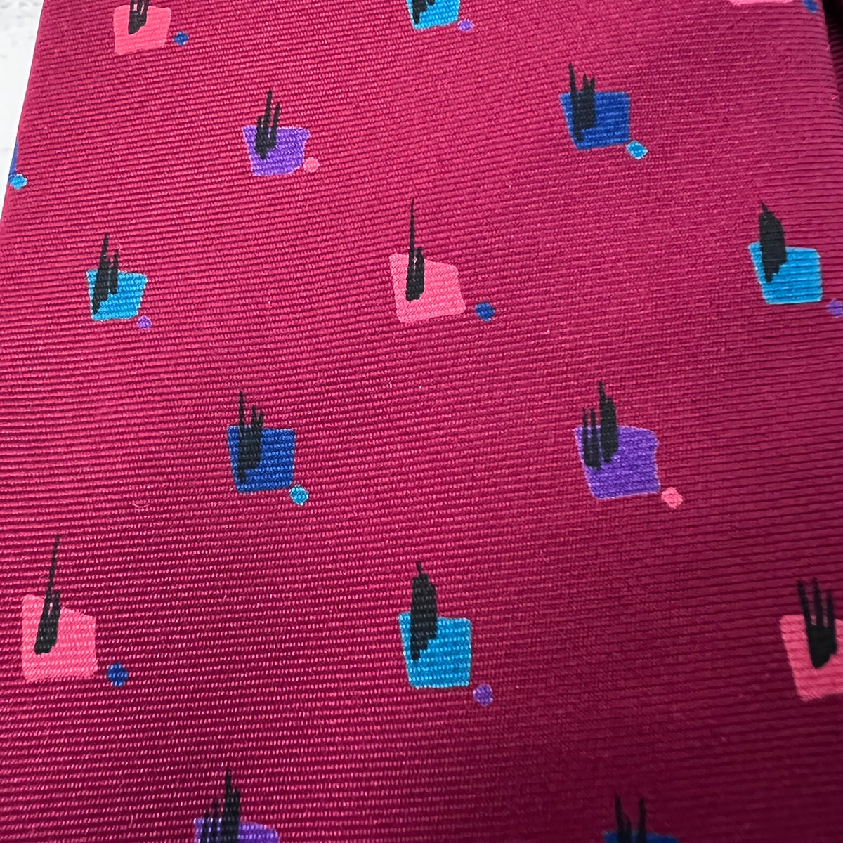 Patterned fabric with small colorful shapes on a red background