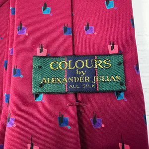Close-up of a red tie with a 'Colours by Alexander Julian' label.