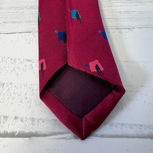 Maroon tie with geometric pattern on a textured white surface