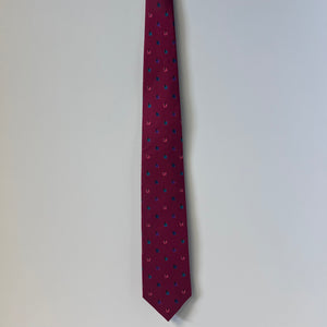 Maroon tie with small pattern on a light gray background